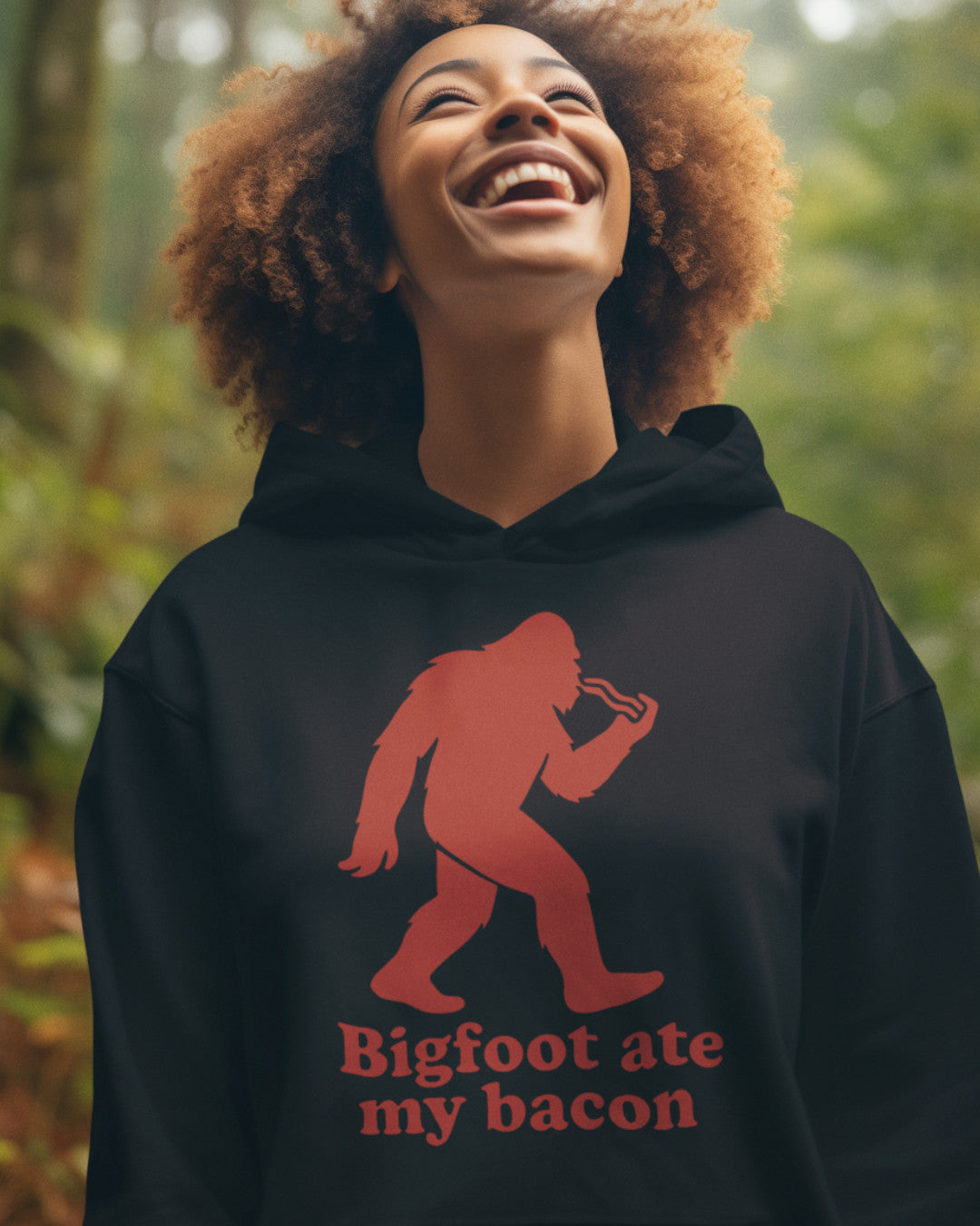 Woman wearing a  Bigfoot Ate My Bacon Hoodie