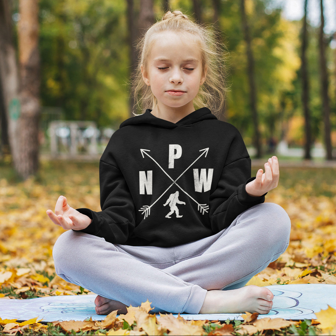 young girl wearing a black PNW crossed arrows Bigfoot hoodie